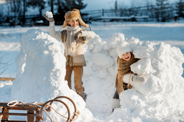 Deux enfants qui s'amusent dans la neige en hiver